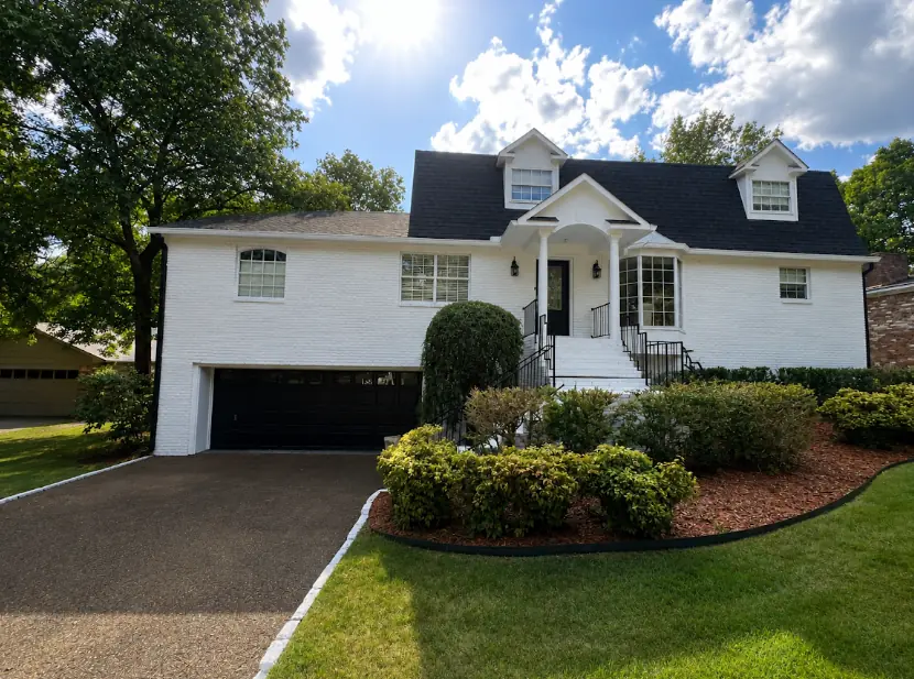 White two-story house with black trim after exterior painting