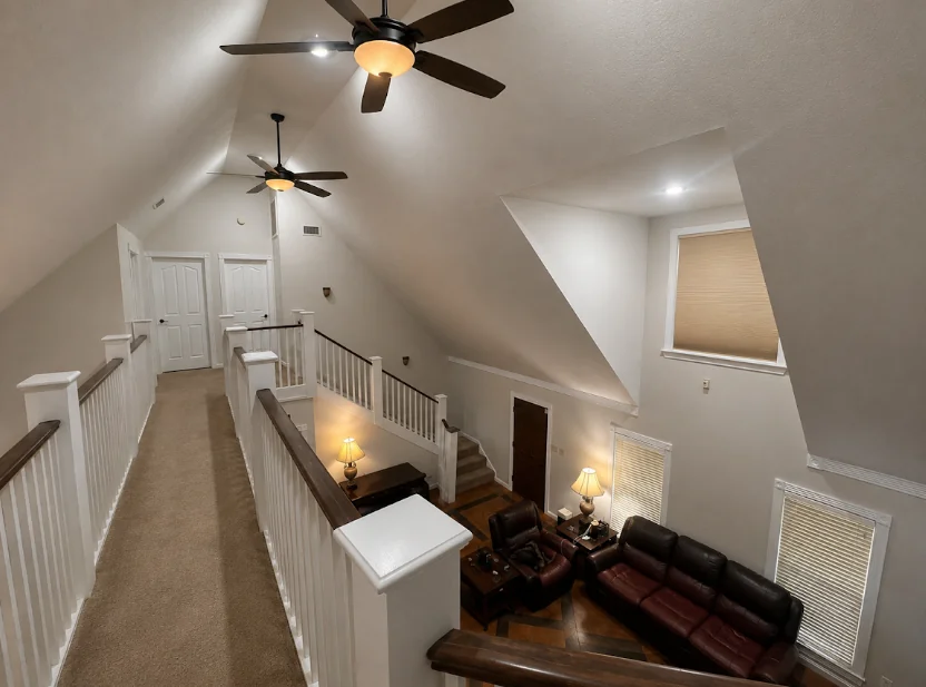 Upstairs hallway with freshly painted walls and railing