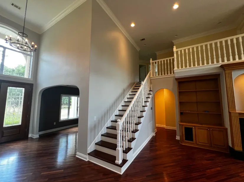 Entry with a painted staircase railing and fresh walls
