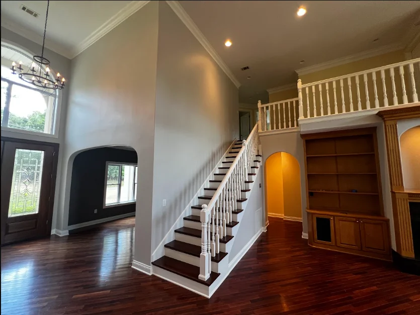 Two-story entry with a painted stair railing